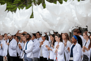 Medical students hold dove-shaped, environmentally friendly balloons during a ceremony led by first-year medical students at Washington University School of Medicine in St. Louis.